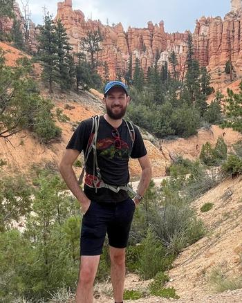 Man hiking in featured photo for Colorado nonprofit helping kids who have lost parents