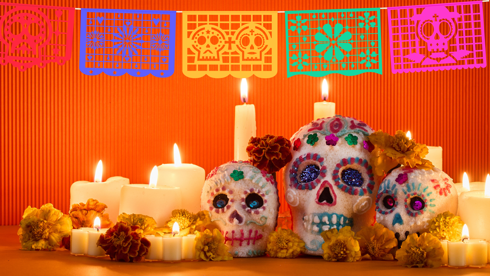 colorful day of the dead decorated skulls and candles